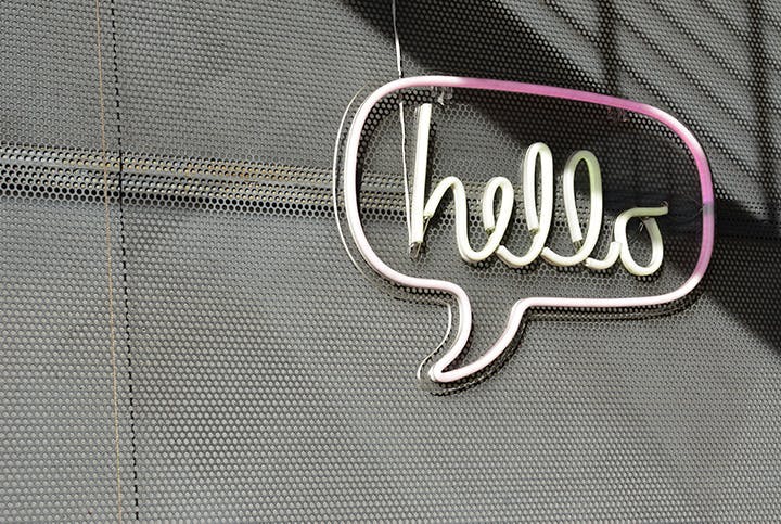 Speech bubble neon sign with 'hello' inside of it